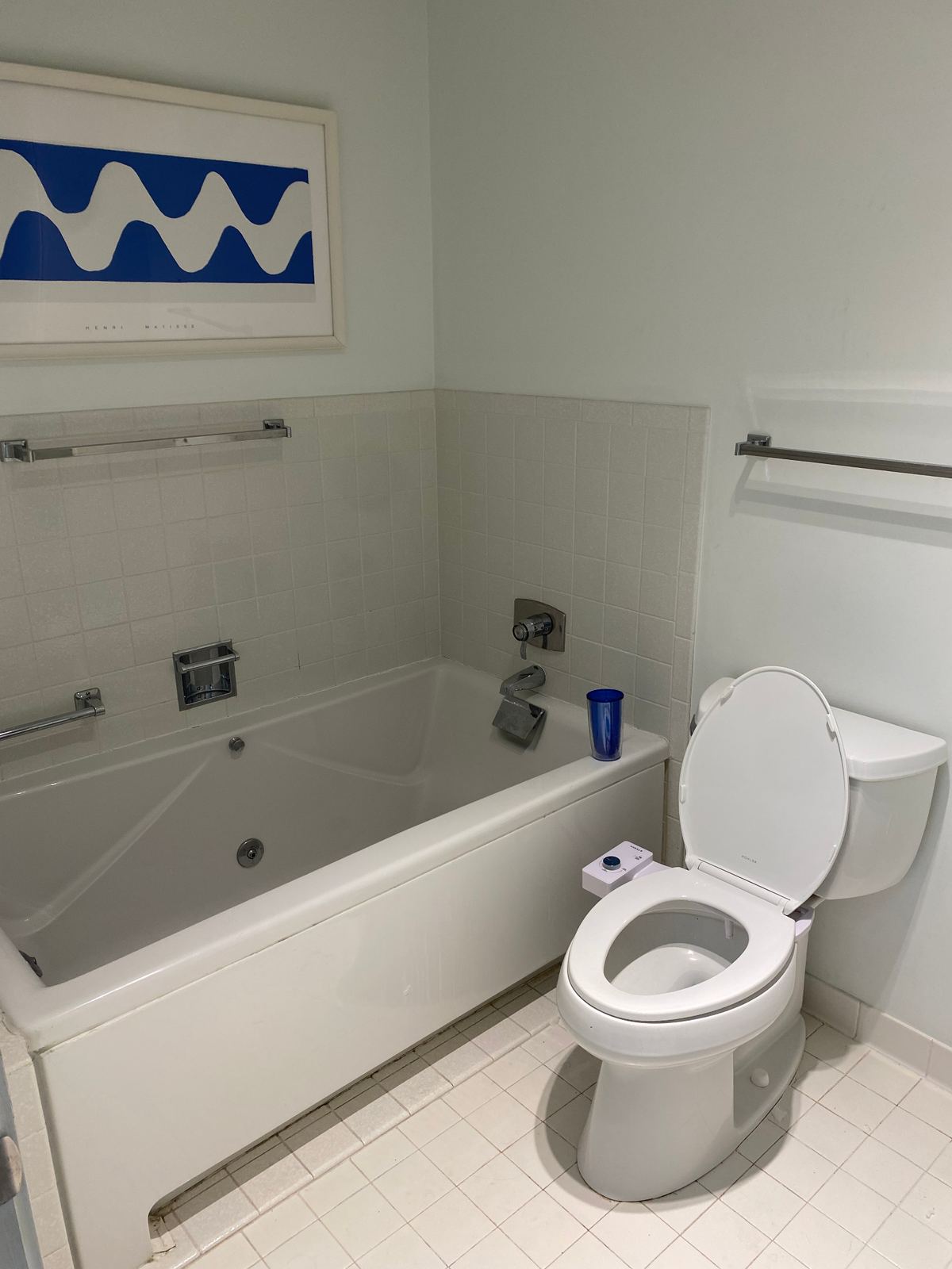 Original built-in jetted tub with dated white tile surround before renovation