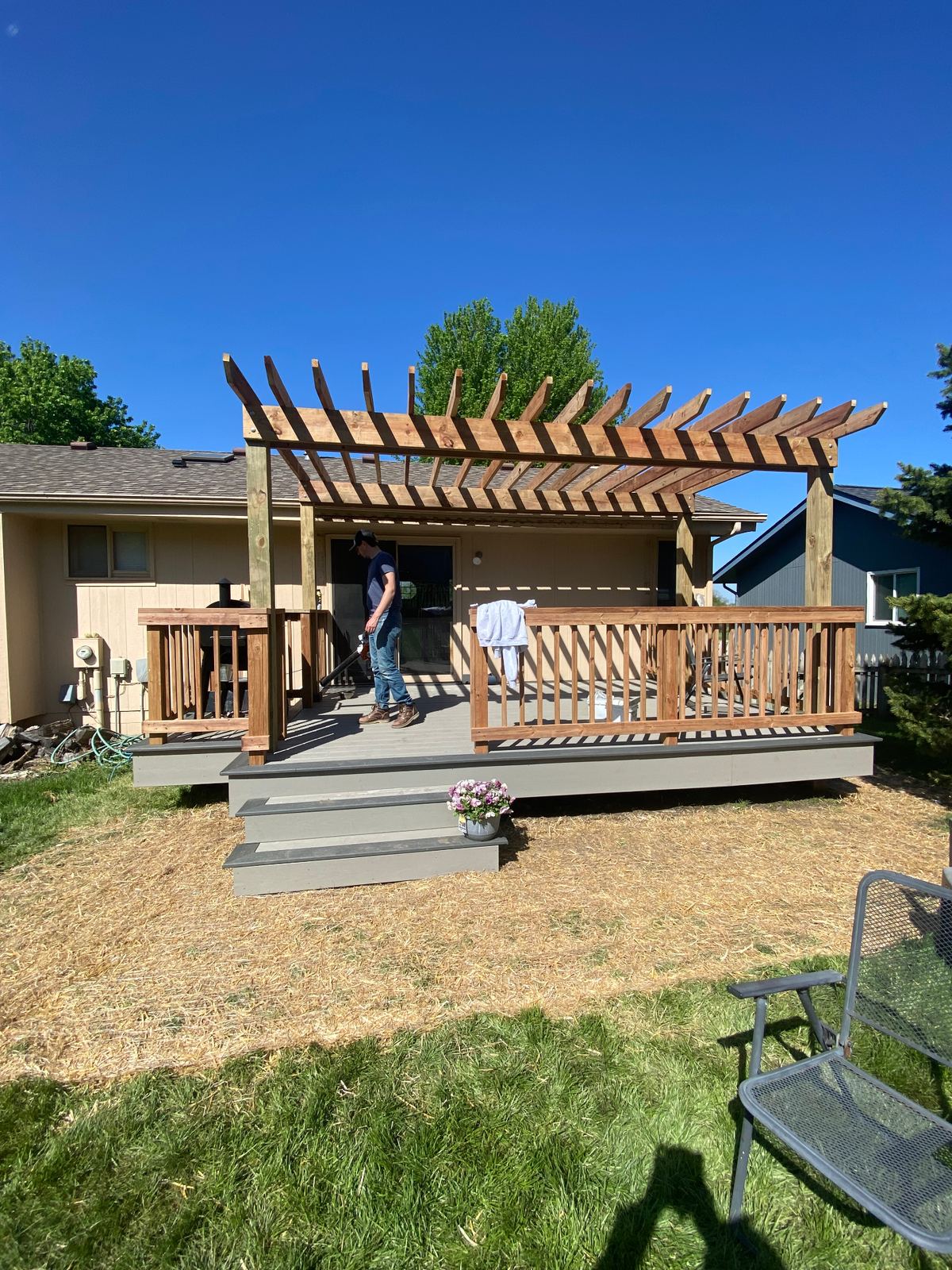 Backyard composite deck with cedar pergola and railing