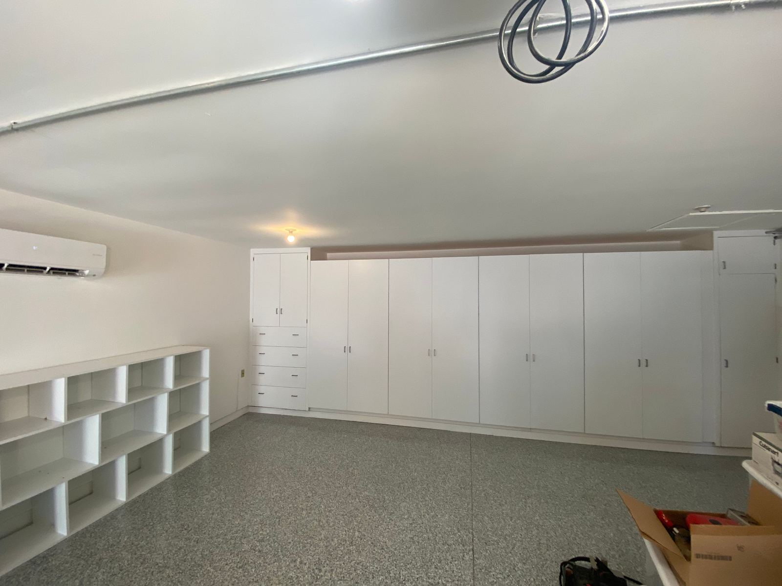 Finished garage with cubby shelving, mini-split, and full storage wall