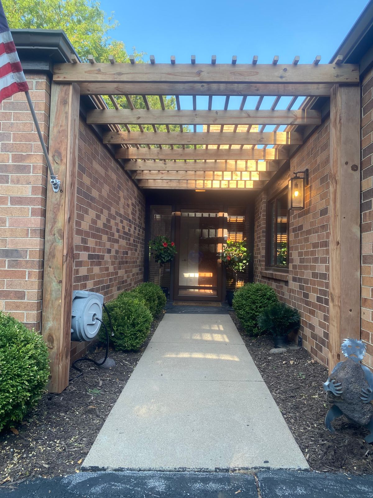 Front entry with new cedar pergola over brick walkway